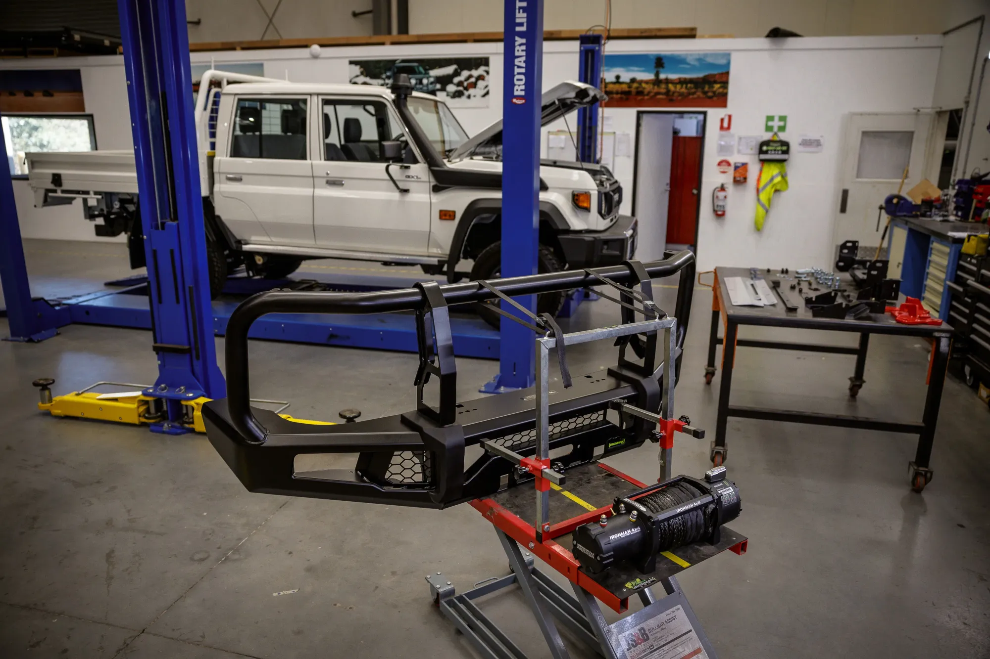 A white 79 Series in a build workshop with a new bar and accessories ready to fit